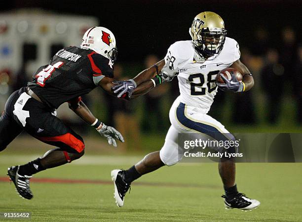 Dion Lewis of the Pittsburgh Panthers runs with the ball while defended by Chaz Thompson of the Louisville Cardinals during the Big East Conference...