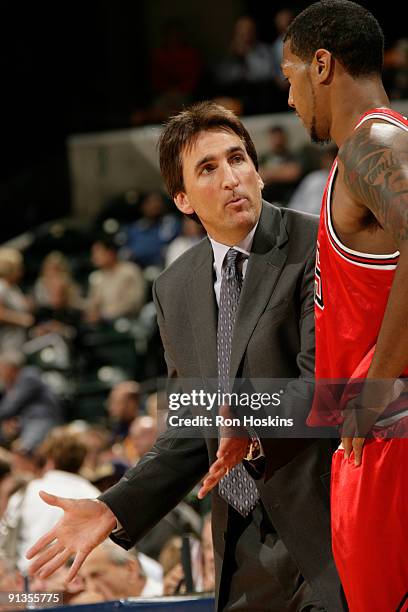 Chicago Bulls head coach, Vinny Del Negro, talks with James Johnson of the Bulls as they took on the Indiana Pacers during the preseason at Conseco...