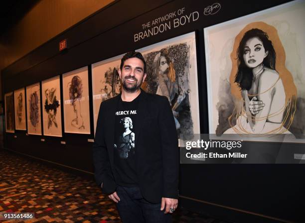 Hard Rock Hotel & Casino curator Beau Dobney poses in front of a display of fine art giclee prints by singer Brandon Boyd of Incubus outside The...