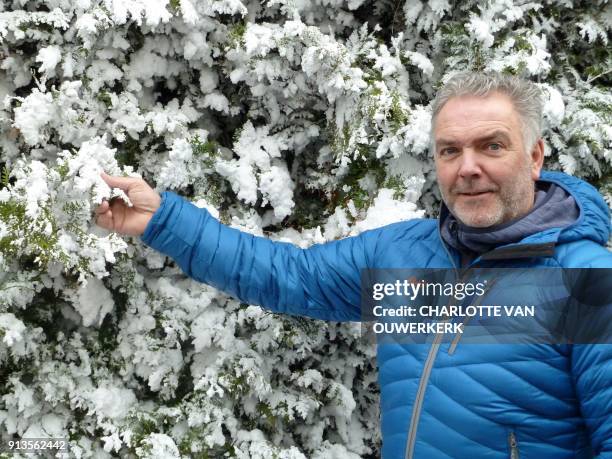 Former Dutch freestyle skier Michiel de Ruiter poses next to a snow-covered tree in 's-Graveland on January 25, 2018. They call him Mr Snowman. But...