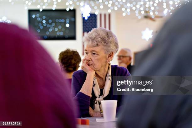 Woman listens as Representative John Delaney, a Democrat from Maryland and 2020 presidential candidate, not pictured, speaks during a Clinton County...
