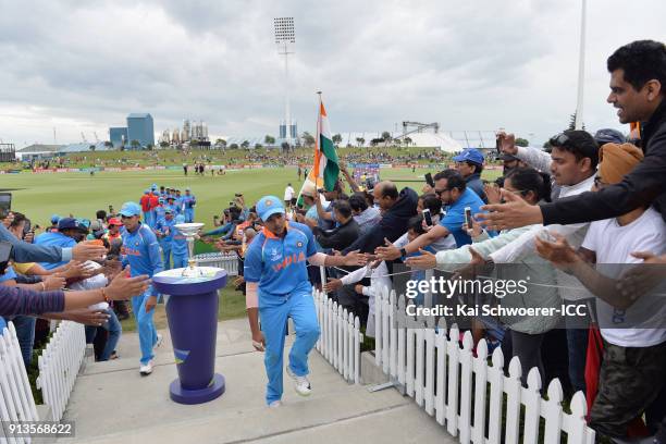 Captain Prithvi Shaw of India walks past the trophy as he greets fans while he walks from the ground at the dinner break during the ICC U19 Cricket...