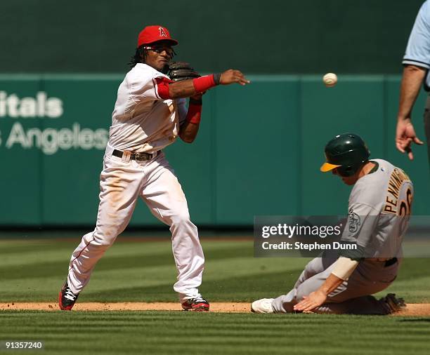 Shortstop Erick Aybar of the Los Angeles Angels of Anaheim throws to first after forcing out Cliff Pennington of the Oakland Athletics on September...