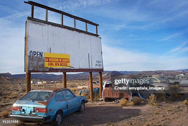 junkyard billboard desert landscape and sky - rusty old car stock pictures, royalty-free photos & images