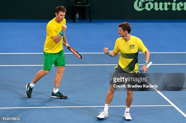 Matt Ebden and John Peers of Australia celebrate winning the fourth set in the doubles match against Jan-Lennard Struff and Tim Putz of Germany...