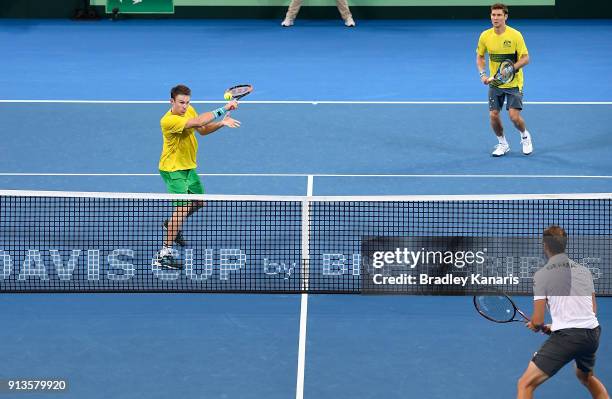 John Peers of Australia plays a backhand volley in the doubles match with Matt Ebden against Jan-Lennard Struff and Tim Putz of Germany during the...