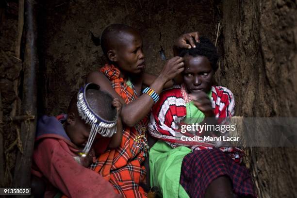 Naanyu Sekut cries while her head is shaved in preparation for her wedding day August 12, 2007 in Kameli, Kenya. She is approximately 13-14 years old...