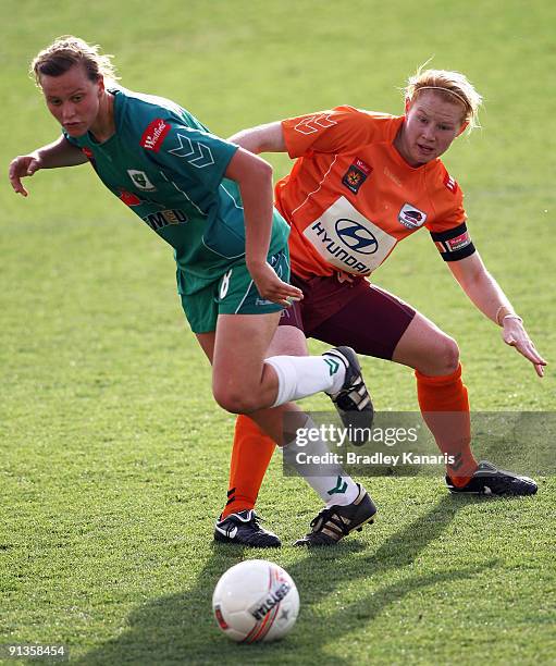 Emily Van Egmond of United and Clare Polkinghorne of the Roar compete for the ball during the round one W-League match between the Brisbane Roar and...