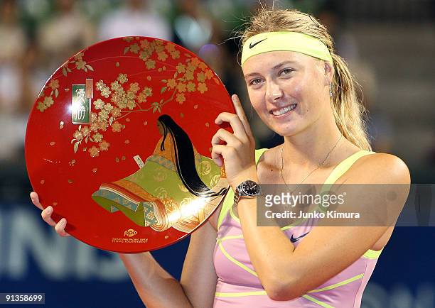 Maria Sharapova of Russia poses with the trophy after winning the women's final match against Jelena Jankovic of Serbia during day seven of the Toray...