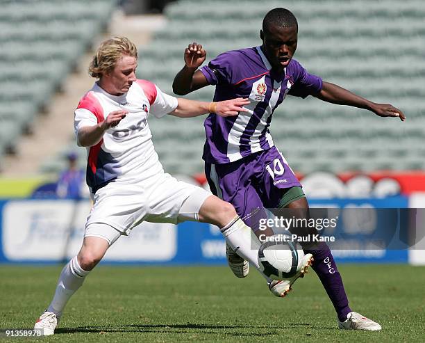 Christopher Bush of the AIS and Million Butshiire of the Glory compete for the ball during the round four National Youth League round four match...