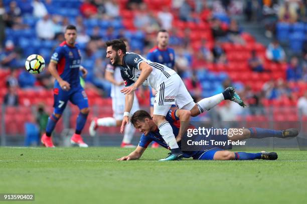 Nigel Boogaard of the Jets contests the ball with Christian Theoharous of the Victory during the round 19 A-League match between the Newcastle Jets...
