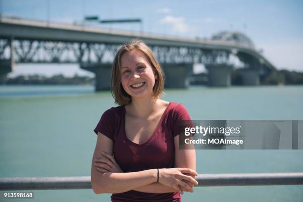 a young caucasian girl is standing by the sea in auckland - portrait solid stock pictures, royalty-free photos & images