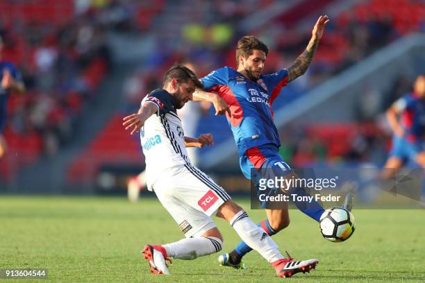 Matias Sanchez of the Victory contests the ball with Patricio Rodriguez of the Jets during the round 19 A-League match between the Newcastle Jets and...