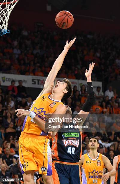 Dane Pineau of the Kings attempts to collect a rebound against Alex Loughton of the Taipans during the round 17 NBL match between the Cairns Taipans...