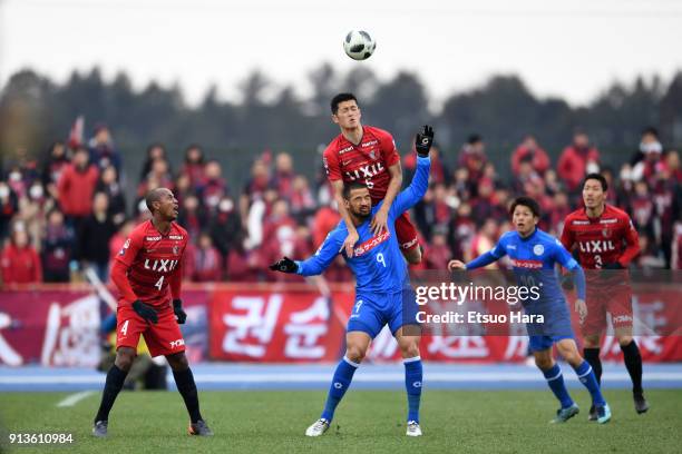 Naomichi Ueda of Kashima Antlers and Jefferson Baiano of Mito Hollyhock compete for the ball during the preseason friendly match between Mito...