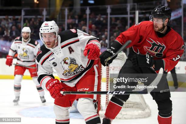 Cleveland Monsters defenceman Brady Austin defends against Grand Rapids Griffins center Ben Street during the first period of the American Hockey...