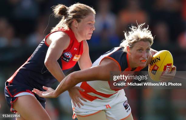 Cora Staunton of the Giants is tackled by Ashleigh Guest of the Demons during the 2018 AFLW Round 01 match between the Melbourne Demons and the GWS...