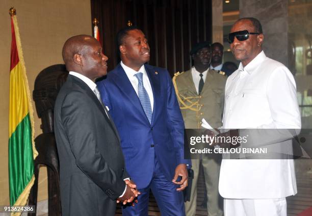 Guinee Bissau President Jose Mario Vaz, Togo President Faure Gnassingbe and Guinean President Alpha Conde talk after a meeting on February 2, 2018 at...