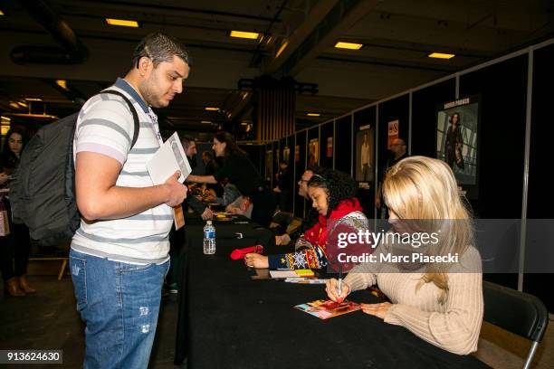 Actress Pamela Anderson signs autographs as she attends the '25th Paris Manga & Sci-Fi Show' at Parc des Expositions Porte de Versailles on February...