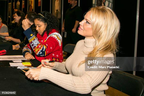 Actress Pamela Anderson signs autographs as she attends the '25th Paris Manga & Sci-Fi Show' at Parc des Expositions Porte de Versailles on February...