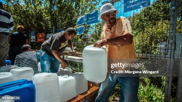 Cape Town residents queue to refill water bottles at Newlands Spring on January 31, 2018 in Cape Town, South Africa. Diminishing water supplies may...