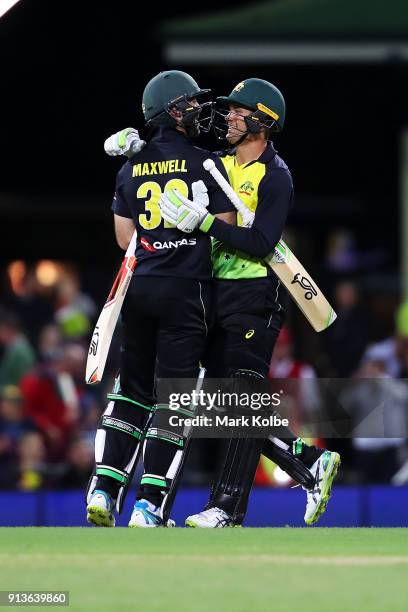 Glenn Maxwell and Alex Carey of Australia celebrate victory during game one of the International Twenty20 series between Australia and New Zealand at...