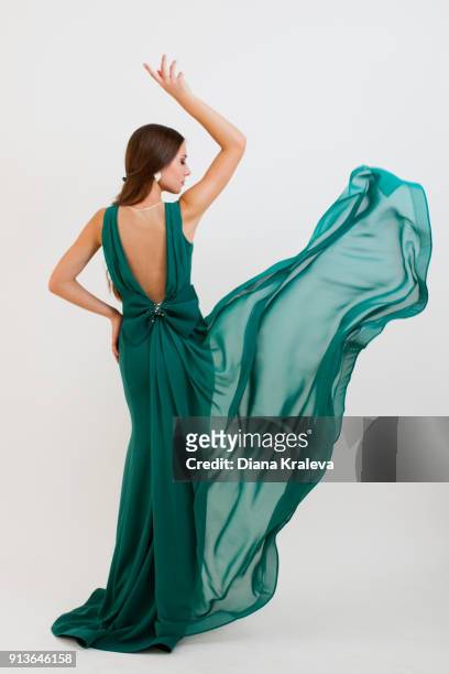 young woman with elegant green dress - woman in evening dress stock-fotos und bilder