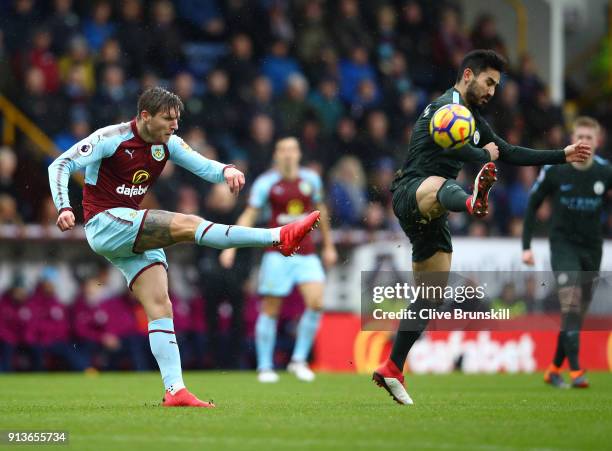 Jeff Hendrick of Burnley shoots as Ilkay Gundogan of Manchester City attempts to block during the Premier League match between Burnley and Manchester...