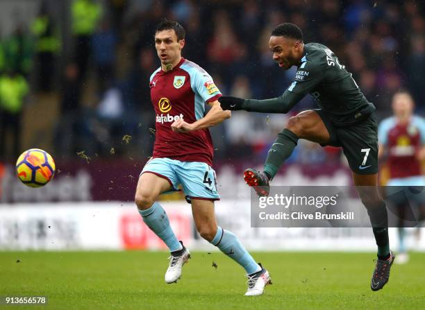 Raheem Sterling of Manchester City shoots past Jack Cork of Burnley during the Premier League match between Burnley and Manchester City at Turf Moor...