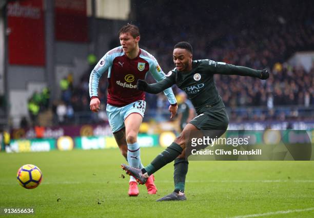 Raheem Sterling of Manchester City shoots past Jeff Hendrick of Burnley during the Premier League match between Burnley and Manchester City at Turf...