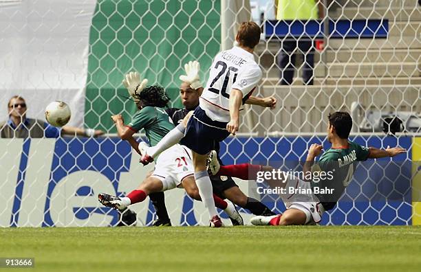 Brian McBride of the USA shoots past Jesus Arellano, Oscar Perez and Rafael Marquez during the Mexico v USA, World Cup Second Round match played at...