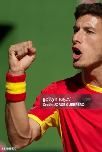 Spain's Pablo Carreno gestures during his tennis doubles match against Britons Jamie Murray and Dominic Inglot of the first round of the Davis Cup...