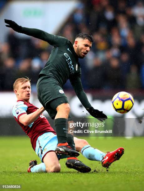 Ben Mee of Burnley tackles Sergio Aguero of Manchester City during the Premier League match between Burnley and Manchester City at Turf Moor on...