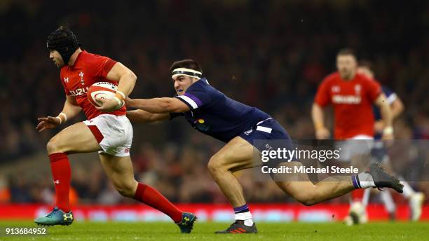 Stuart McInally of Scotland chases down Leigh Halfpenny of Wales during the Natwest Six Nations round One match between Wales and Scotland at...