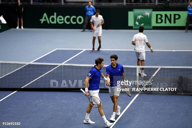 France's Pierre-Hugues Herbert and France's Nicolas Mahut celebrate as they play against Netherlands' Jean-Julien Rojer and Netherlands' Robin Haase...
