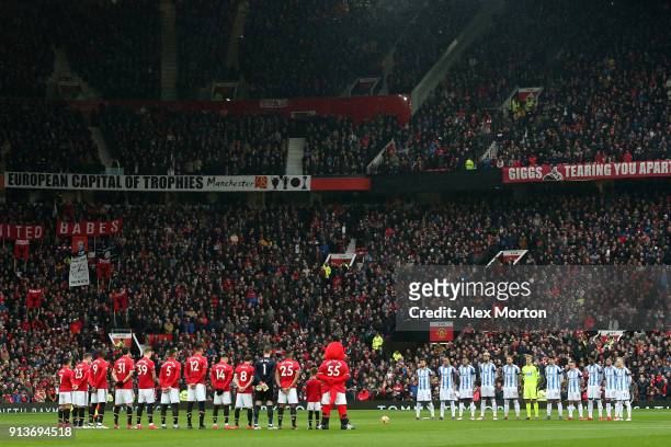 Fans, officials and players take part in a minute silence in tribute to the Manchester United players involved in the Munich disaster ahead of the...