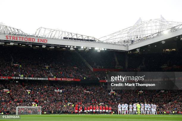 Fans, officials and players take part in a minute silence in tribute to the Manchester United players involved in the Munich disaster ahead of the...
