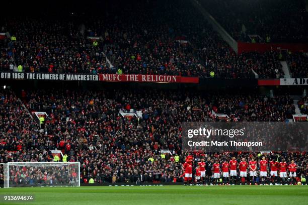 Fans, officials and players take part in a minute silence in tribute to the Manchester United players involved in the Munich disaster ahead of the...