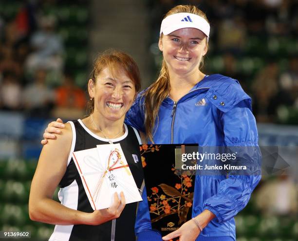 Ai Sugiyama of Japan and Daniela Hantuchova of Slovakia pose with the trophy after playing their doubles final match against Francesca Schiavone of...