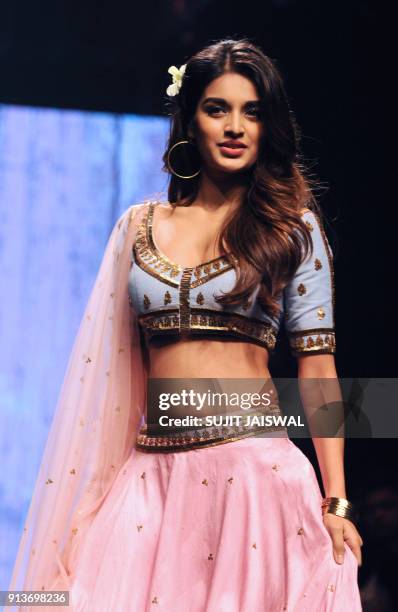 Indian Bollywood actress Nidhhi Agerwal showcases a creation by designer Suloka Sudhakar at the Lakmé Fashion Week Summer Resort 2018 in Mumbai on...