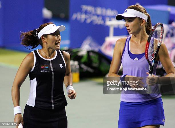 Ai Sugiyama of Japan and Daniela Hantuchova of Slovakia talk in their doubles final match against Francesca Schiavone of Italy and Alisa Kleybanova...