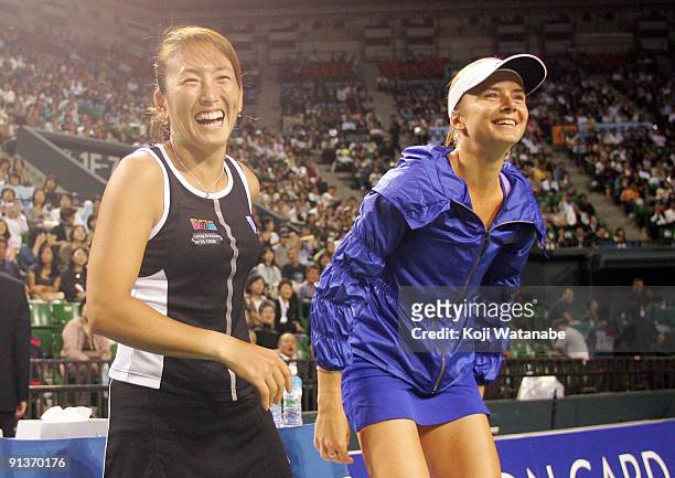 Ai Sugiyama of Japan and Daniela Hantuchova of Slovakia laughafter playing their doubles final match against Francesca Schiavone of Italy and Alisa...