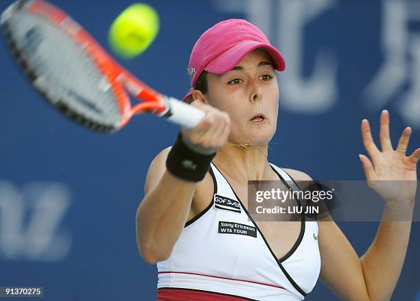 Alize Cornet of France hits a return to Samantha Stosur of Australia during a first round match of the China Open 2009 at the National Tennis Centre...