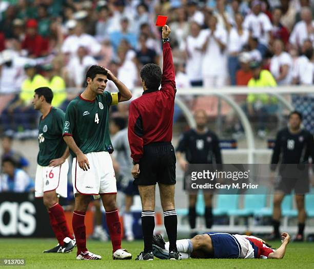 Rafael Marquez of Mexico is sent off by referee Vitor Melo Pereira for a foul on Cobi Jones of the USA during the Mexico v USA, World Cup Second...