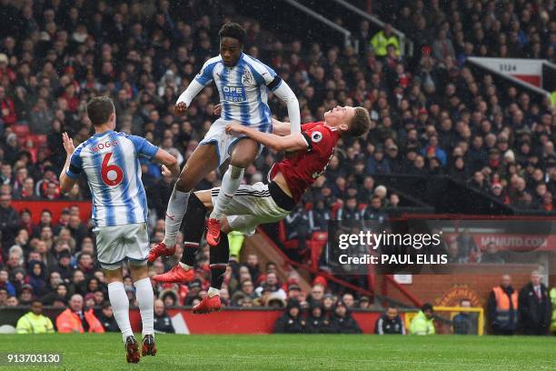 Huddersfield Town's Swiss-born Dutch defender Terence Kongolo collides with Manchester United's English midfielder Scott McTominay in the penalty...