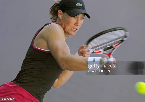 Samantha Stosur of Australia returns a shot to Alize Cornet of France during their first round match of the China Open 2009 at the National Tennis...