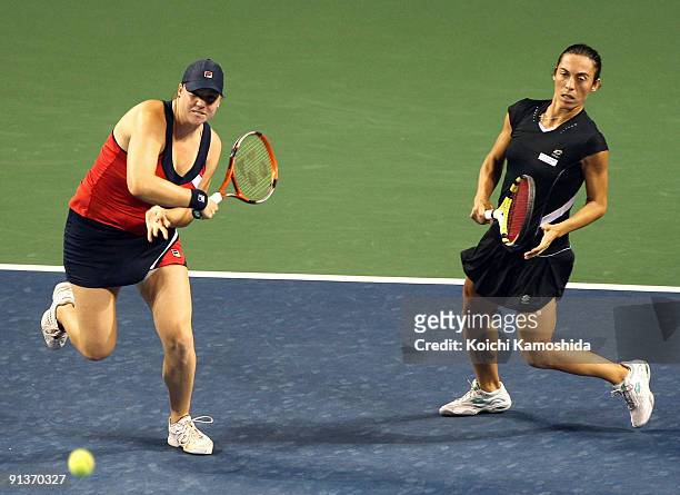 Francesca Schiavone of Italy and Alisa Kleybanova of Russia to return the ball in the doubles final match against Ai Sugiyama of Japan and Daniela...