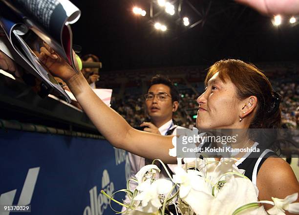 Ai Sugiyama of Japan signs autographs for her fans after a ceremony during day seven of the Toray Pan Pacific Open Tennis tournament at Ariake...