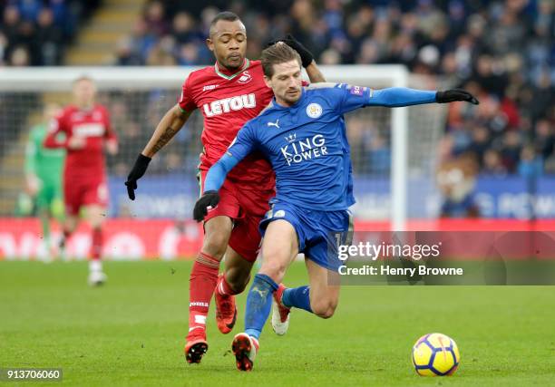 Adrien Silva of Leicester City is tackled by Jordan Ayew of Swansea City during the Premier League match between Leicester City and Swansea City at...