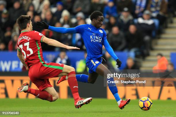 Fousseni Diabate of Leicester City shoots under pressure from Federico Fernandez of Swansea City during the Premier League match between Leicester...